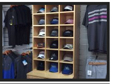 Curated polos and headwear shelving